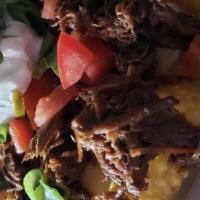 Pot Roast Nachos · Choice of tortilla chips or fries topped with cheddar cheese sauce, shredded pot roast, toma...