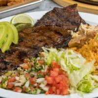 Carne Asada · Char-grilled skirt steak, served with rice and beans, pico de gallo, sour cream, and house m...