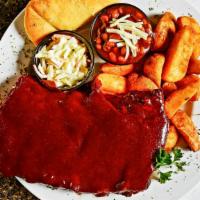 Slab (1/2) Dinner · Half rack of tender ribs served with fries and bread.

Cooked to order. Consuming raw or und...