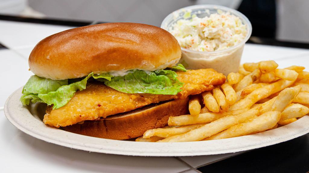 Fish Sandwich Deluxe · Crispy delicate flounder fillet on a brioche bun topped with lettuce and tartar sauce. Served with one side dish and a cole slaw.