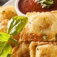 Fried Ravioli (8Pc) · Ravioli stuffed with cheese or meat then breaded. served with parmesan and homemade marinara.