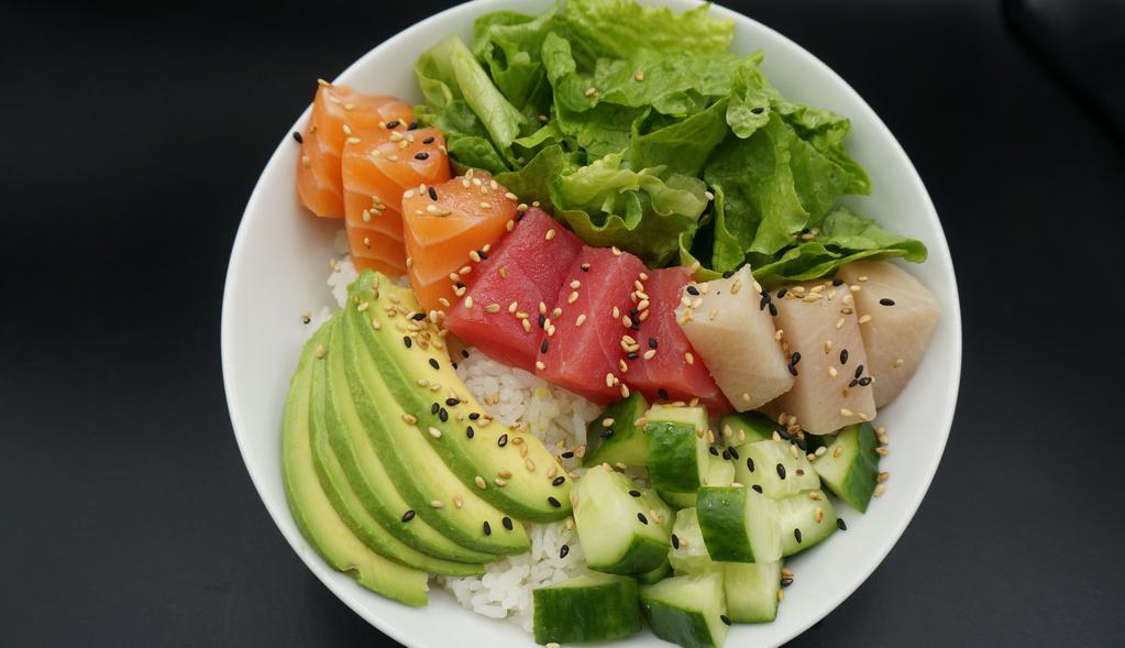 Chirashi Bowl · Sushi Rice, green leaf lettuce, cucumber, avocado, Salmon, Tuna, Yellow Tail topped with sesame seeds.