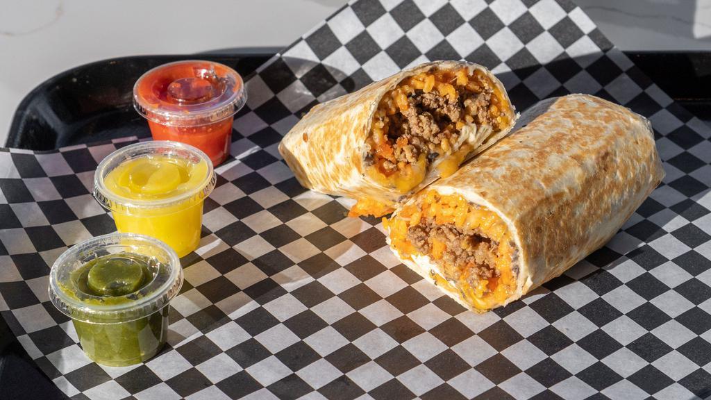 Ground Beef & Sautéed Onions Burrito · Ground beef and sautéed onions with Mexican yellow rice and Texas style black beans on a flour tortilla with shredded cheddar and Monterey jack cheese.