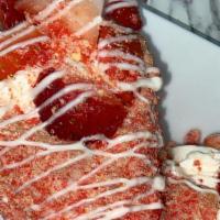 Strawberry Crunch Cheesecake Waffle Cone · filled with cheesecake and topped with strawberry slices