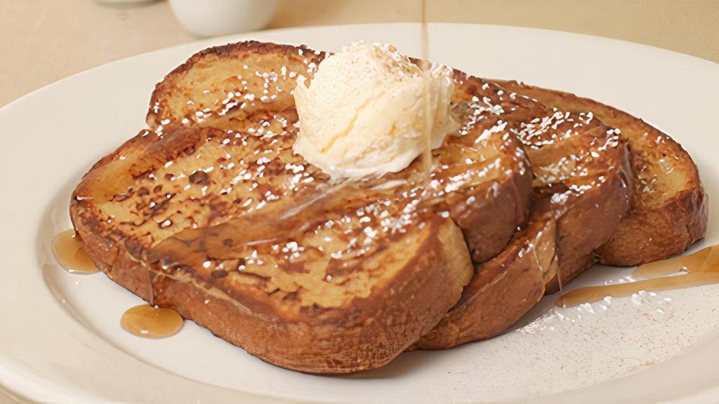 Classic French Toast · Thick-sliced sourdough dipped in. brandied egg batter with whipped. butter, maple syrup, powdered. sugar and cinnamon