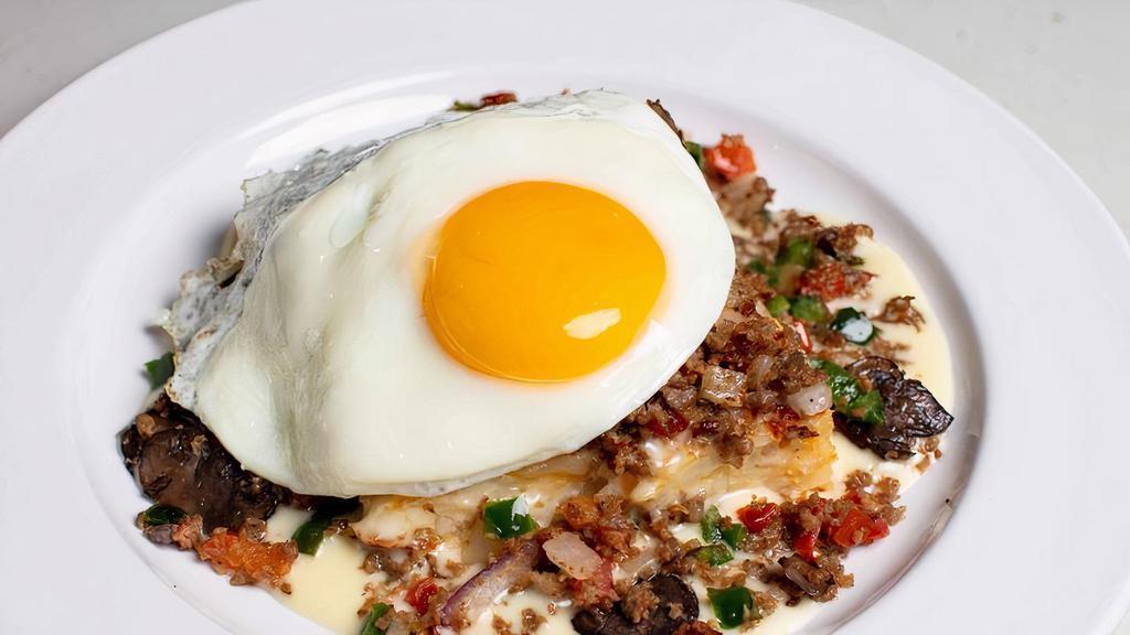 Potato Head Casserole · Hashbrown potatoes baked with. sour cream, diced onions, spices. and cheddar-jack cheese. Topped. with breakfast sausage, diced. tomatoes, poblano pepper,. mushrooms, queso, onions and. an egg your way