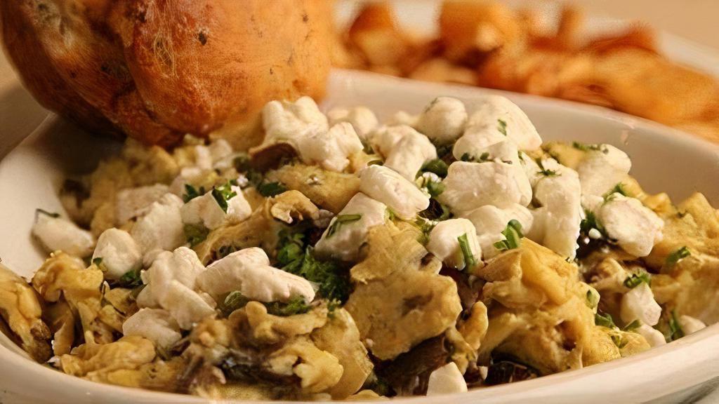 Wild Mushroom & Roasted Garlic Scramble · Wild mushrooms and garlic. folded into four scrambled eggs. with fresh goat cheese and white. truffle oil. Served with skillet potatoes. and an Everything muffin