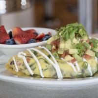 Surfer Girl Omelet · Fresh spinach, wild mushrooms, tomato, cream cheese and onion, topped with diced fresh avoca...