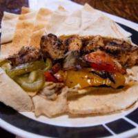 Chicken Shawarma · Grilled marinated slivers of tender and juicy chicken breast in garlic lemon herb.