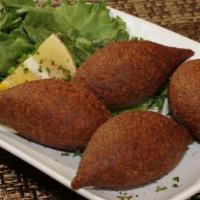 Fried Kibbeh · Four pieces. A shell of bulgur wheat and minced beef stuffed with ground beef, pine nuts and...