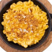 Classic Mac And Cheese · Spiral macaroni, cheddar cheese, and cream. Baked with smoked Gouda and cheddar. Sprinkled w...