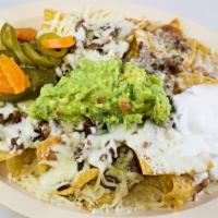 Super Nachos · Choice of meat with beans, cheese, sour cream, guacamole and jalapenos.