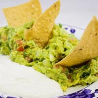 Guacamole With Chips · Avocado dip with chips.