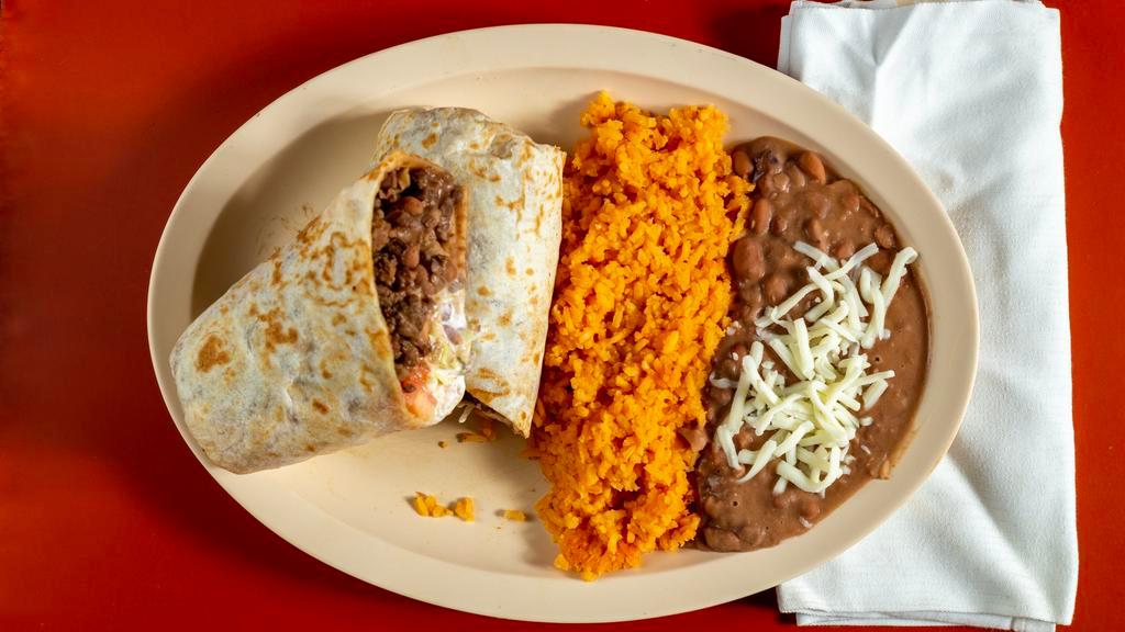 Burrito Dinner · Contains lettuce, tomato, beans, cheese and sour cream. Served with a side of rice and beans.