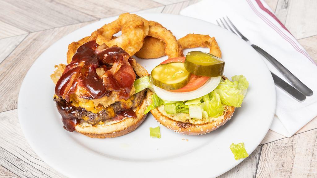 Western Pourman · Fill up with a burger that is topped with bacon, onion straws, cheddar cheese and a sweet BBQ sauce.