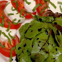 Caprese Salad · Fresh spring greens, sliced tomatoes, fresh mozzarella, pepperoncini, basil, olive oil and b...