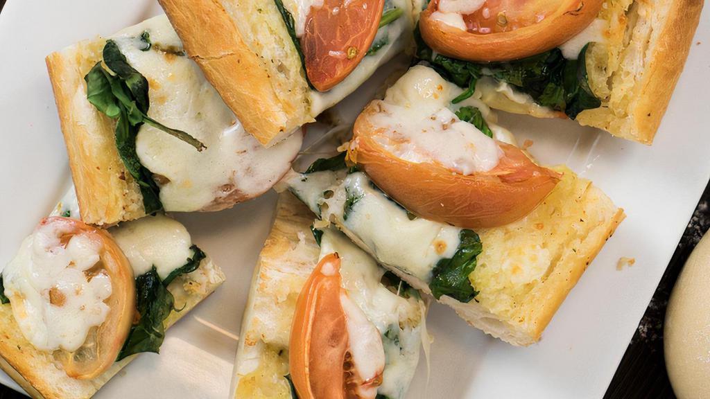 Spinach And Tomato Garlic Bread · Served with melted mozzarella.