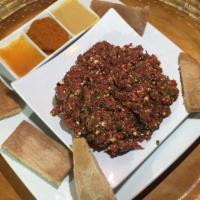 Special Kitfo · Freshly minced, very lean beef with mixed spicy butter and mitmita. Served with homemade Cot...