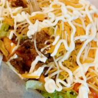 Walking Tacos · Topped with your choice meat, lettuce, onion, tomato, black olives, cheese, sour cream and j...