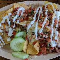 Nachos · Crisp nachos topped with melted mozzarella cheese and served with pico de gallo and sour cre...
