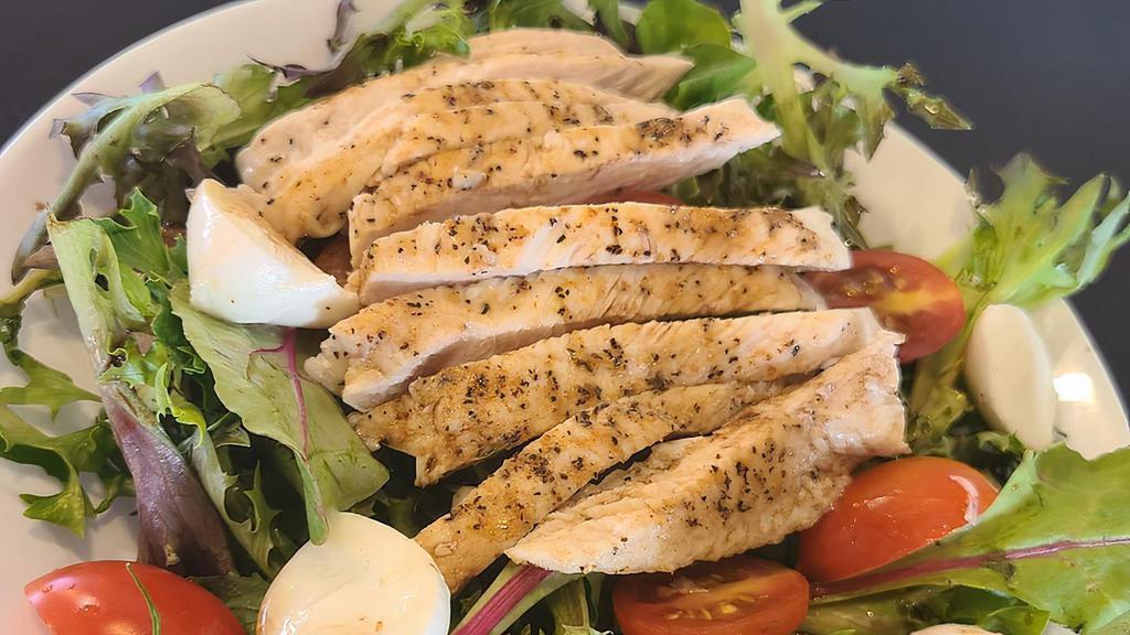 Chicken Ceaser Salad · Crisp romaine lettuce tossed in our creamy parmesan Caesar dressing, topped with sliced grilled chicken, crunchy croutons, tomatoes, and parmesan cheese.