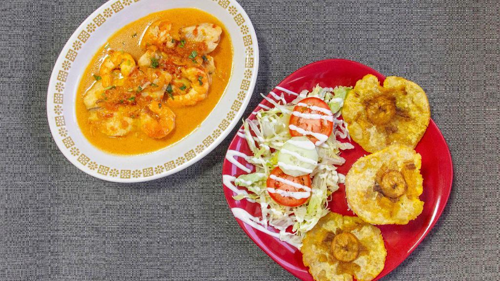 Plato Caribeno · Fish fillet, cooked shrimp, house special sauce, served with rice, salad, and patacones.