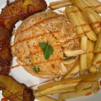 Arroz Con Pollo · Rice with mix chicken and vegetables, served with French fries and sweet plantains.