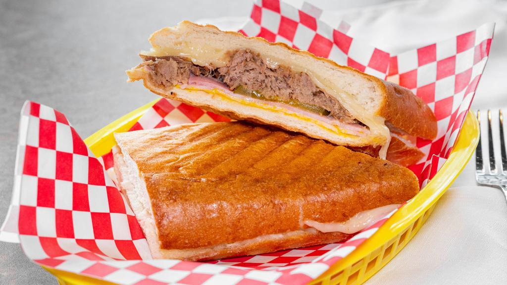 Cubano Sandwich · Ham, cuban pork, swiss, dill pickle, and yellow mustard. Pressed in cuban bread.