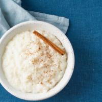 Rice Pudding · Indian rice pudding made out of milk, sugar and spices. Topped with crushed nuts.