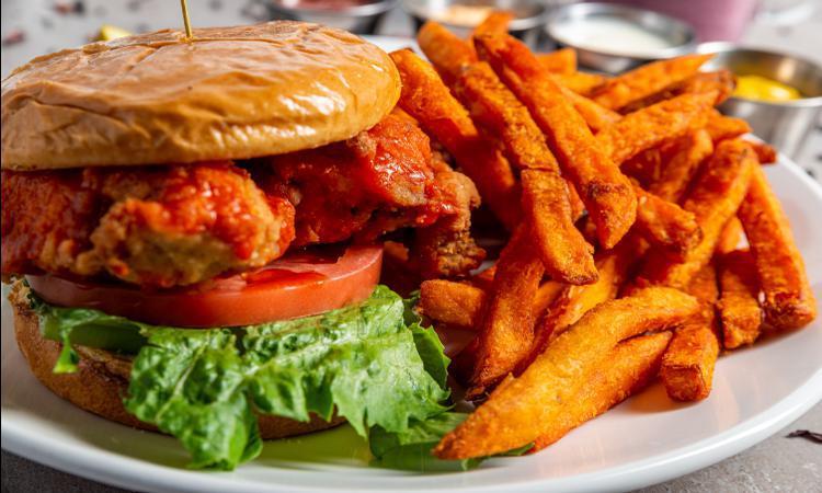*Buffalo Chicken Sandwich · Tender hand breaded chicken breast layered with buffalo sauce, ranch dressing, lettuce, tomato and sliced pickles. Served on a warm brioche bun
