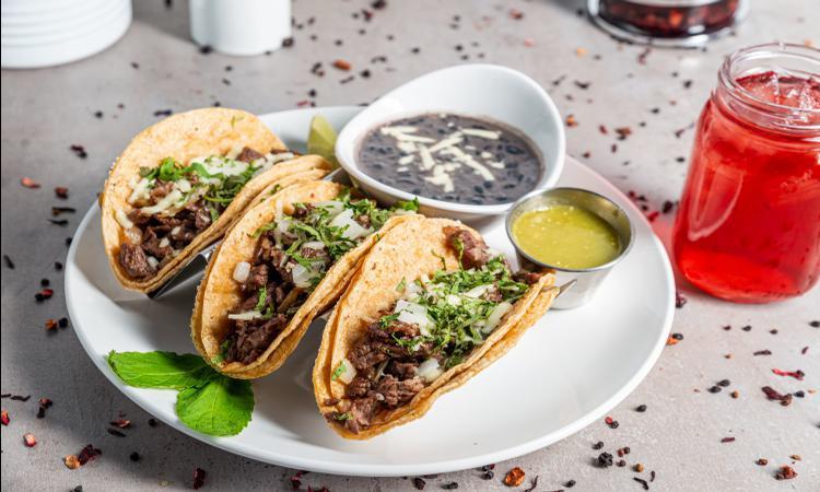 *Steak Tacos · Steak marinated and grilled, topped with onions, queso fresco, and cilantro. Sided with cilantro lime sour cream and salsa verde