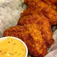 Jalapeño Poppers · Diced jalapeños mixed in with cream cheese and four cheese blend dipped in our signature bat...