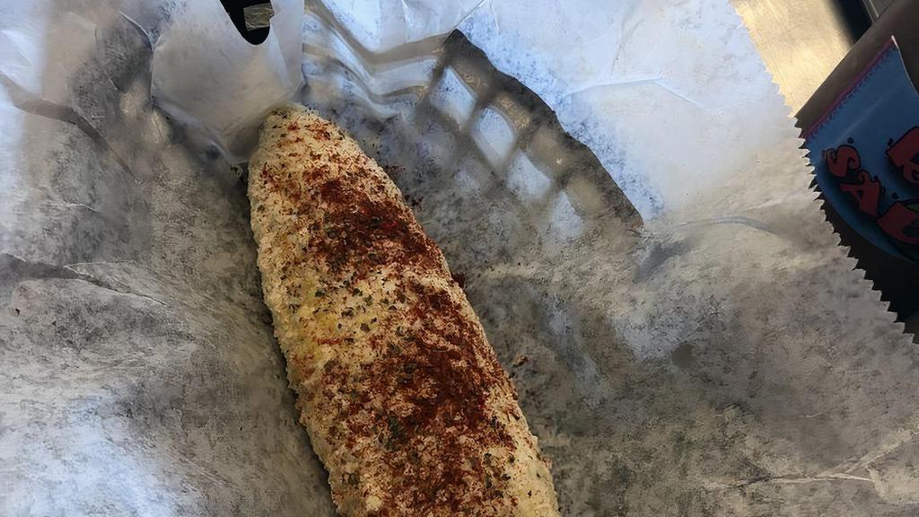 Cali Corn · Juicy corn on the cob, brushed with mayo, sprinkled with Parmesan cheese along with a cilantro and paprika garnish.