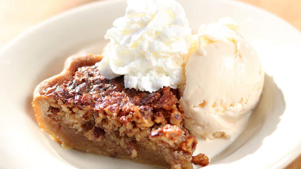 Bourbon Pecan Pie Slice · With caramel drizzle & whipped cream. Made with The Rail Bourbon.