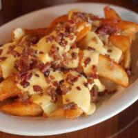 Cheesy Bacon Wedge · Potato Wedges covered with nacho cheese and bacon bits.