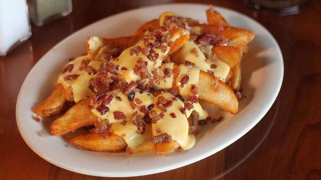 Cheesy Bacon Wedge · Potato Wedges covered with nacho cheese and bacon bits.