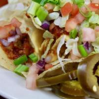 Nachos Deluxe · Tortilla chips, nacho cheese, chili, red onions, shredded lettuce, tomatoes, green onions an...