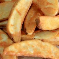 Potato Wedges · Sliced spuds, sealed with savory seasoning.
