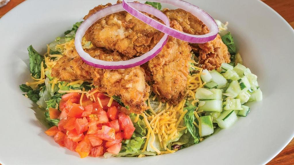 Fried Chicken Salad - Full · Fried chicken tenders over mixed lettucewith cheddar cheese, cucumbers, red onions and tomatoes.