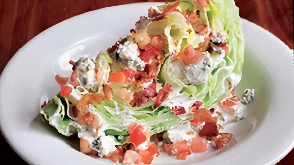 Wedgie Salad · Iceberg wedge drizzled with yourfavorite salad dressing. Topped withbleu cheese crumbles, bacon bits and diced tomatoes.