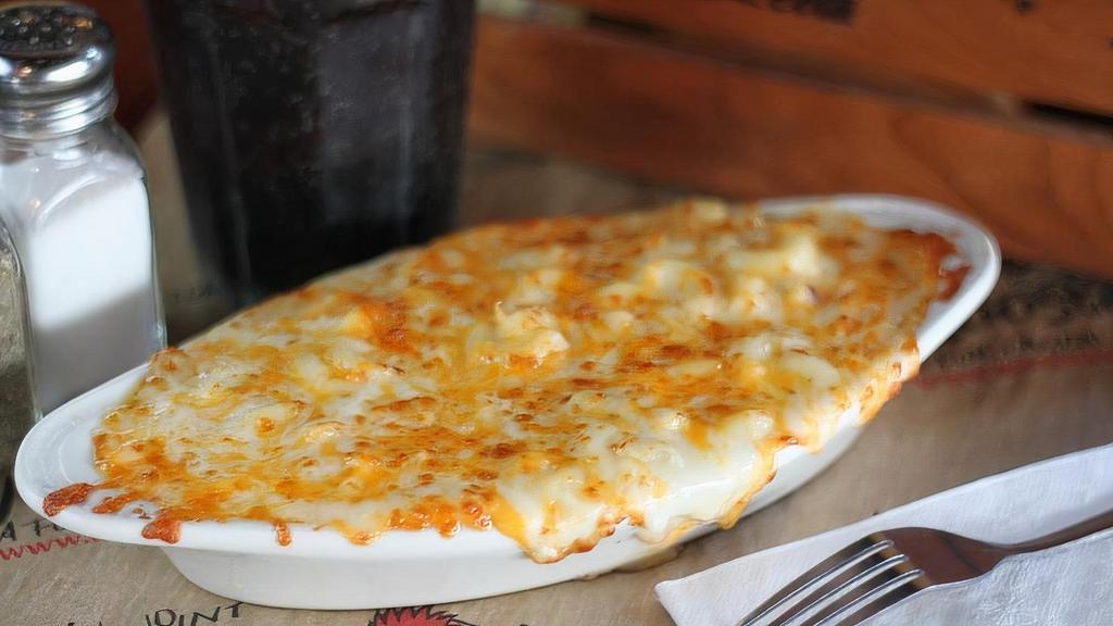Baked Macaroni & Cheese · Macaroni with creamy white cheddar cheese, topped with mozzarella, provolone and cheddar. Baked to a golden brown.
