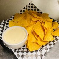 White Spinach Queso + Chips · Blended white cheese, spinach, pico de gallo, roasted chilies, tortilla chips. Great for sha...