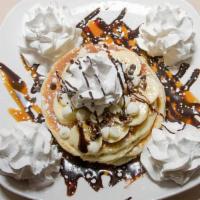 Chunky Monkey Pancakes · Pecans, white chocolate chips, bananas, caramel, and chocolate syrup.