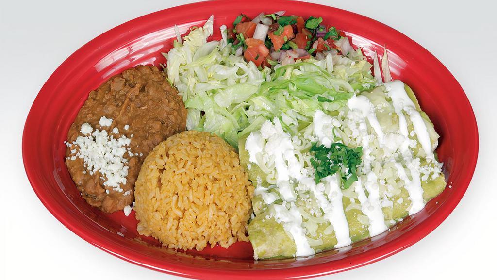Enchiladas · Three corn tortillas rolled with your choice of meat or just cheese, topped with green or red salsa, sprinkled with cheese and sour cream. Served with rice, beans, lettuce, and pico de gallo.