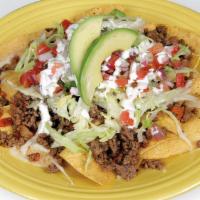 Sunrise Nachos · Corn tortilla chips topped with beans, cheese, ground beef, lettuce, pico de gallo, sour cre...