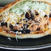 Arepa · Shredded beef or chicken, avocado-herb sauce, plantains, mix cheese, black beans.