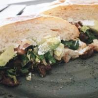 Torta · Grilled asda meat, refried beans, sour cream, avocado slices, crumbled fresco cheese, lettuc...
