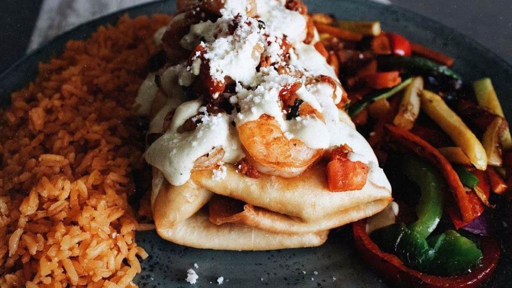 Campeche · Chicken or steak filled topped with jalapeno cream sauce, chorizo-sofrito shrimp and queso fresco. Comes with rice and grilled vegetables