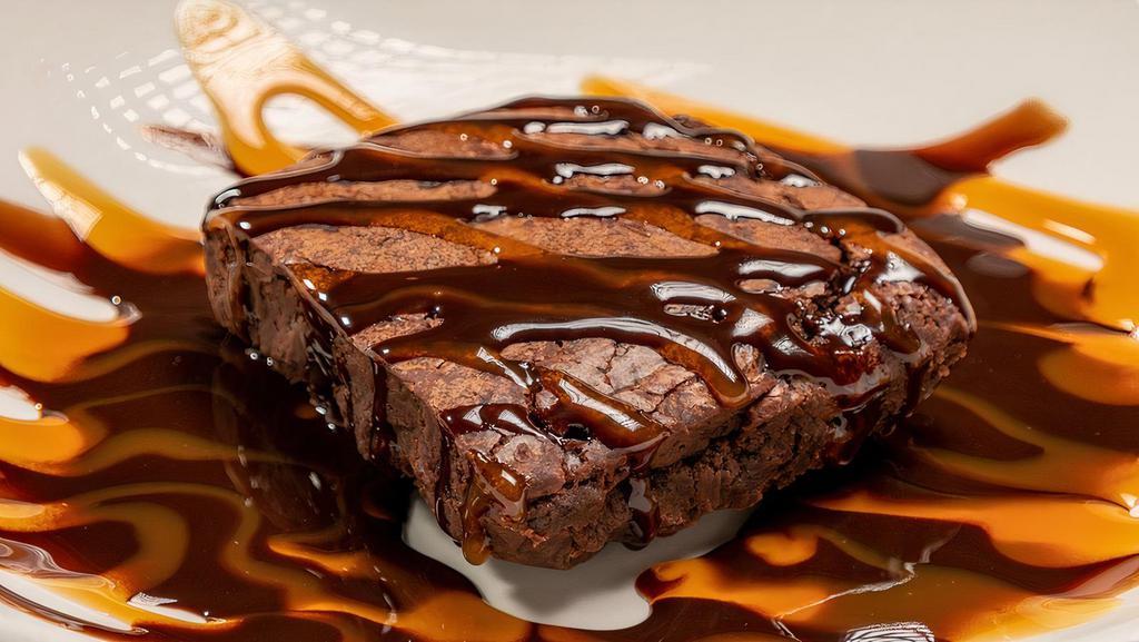 Ghirardelli Triple Chocolate Brownie · Topped with a chocolate and caramel drizzle