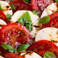 Caprese Salad · Vegetarian. Gluten free. Sliced Roma tomatoes bedded with fresh mozzarella and basil, then d...